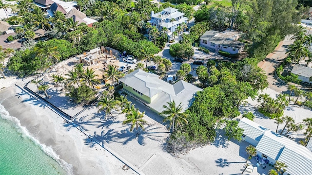 birds eye view of property featuring a view of the beach and a water view