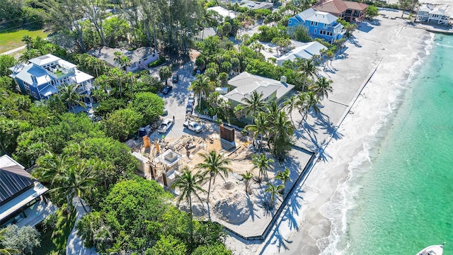 drone / aerial view with a beach view and a water view