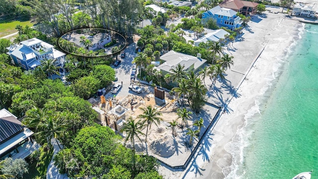 bird's eye view with a beach view and a water view