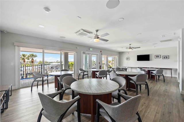 dining space featuring ceiling fan, french doors, and wood-type flooring