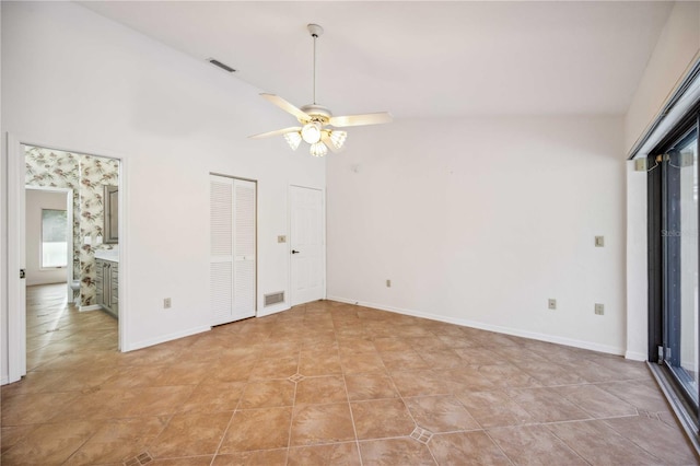 unfurnished bedroom featuring ceiling fan, multiple closets, and light tile patterned flooring