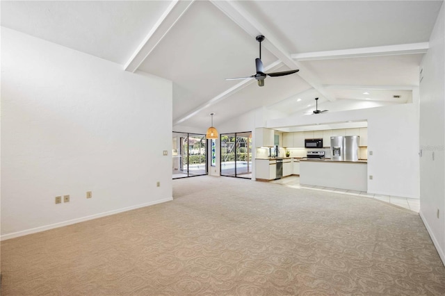 unfurnished living room with vaulted ceiling with beams, ceiling fan, and light colored carpet