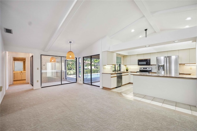 kitchen featuring light carpet, appliances with stainless steel finishes, lofted ceiling with beams, pendant lighting, and white cabinetry