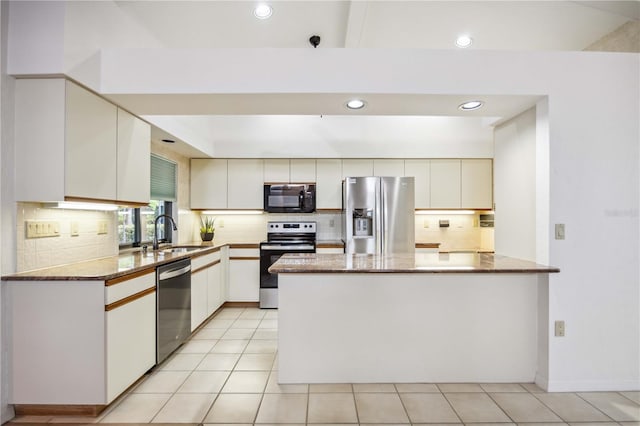 kitchen featuring stone countertops, stainless steel appliances, white cabinetry, and sink