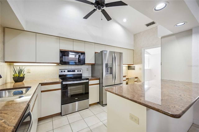 kitchen featuring stainless steel appliances, light stone countertops, ceiling fan, sink, and light tile patterned flooring