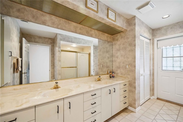 bathroom featuring tile patterned floors, vanity, and walk in shower