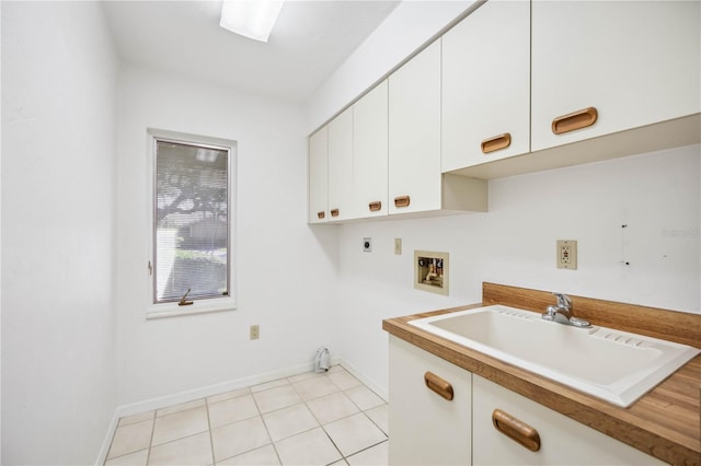 laundry room featuring cabinets, hookup for a washing machine, light tile patterned floors, electric dryer hookup, and sink