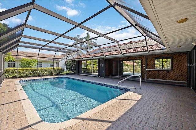 view of pool with a patio area and a lanai