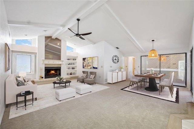 carpeted living room featuring ceiling fan, high vaulted ceiling, and beamed ceiling