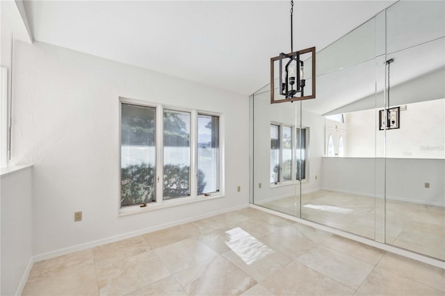 unfurnished bedroom with a chandelier and vaulted ceiling