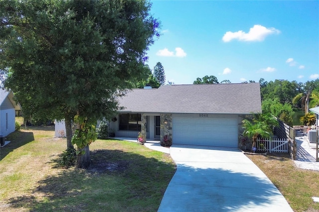 single story home featuring a garage and a front lawn