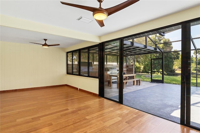 doorway to outside featuring hardwood / wood-style flooring and ceiling fan