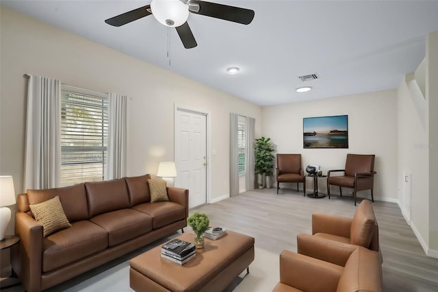 living room featuring ceiling fan and wood-type flooring