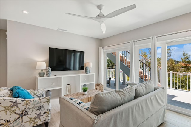 living room with light wood-type flooring and ceiling fan