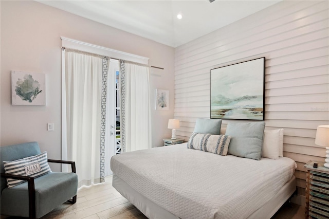 bedroom featuring light hardwood / wood-style floors and access to exterior