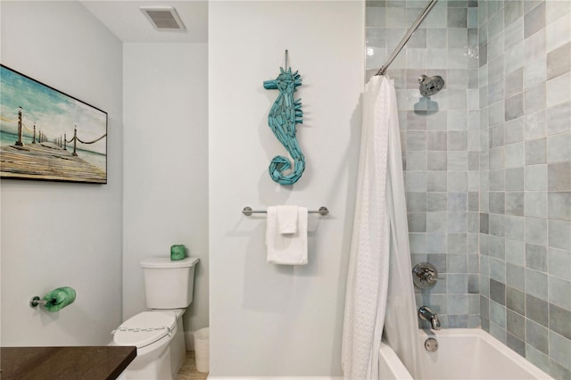 bathroom featuring shower / bath combo and toilet