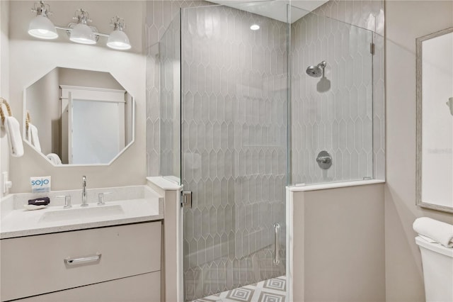 bathroom featuring vanity, toilet, and an enclosed shower