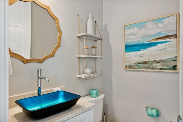 bathroom featuring vanity and toilet