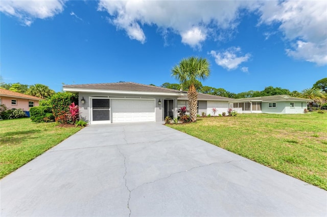 ranch-style home featuring a garage and a front lawn