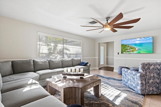 living room featuring tile flooring and ceiling fan