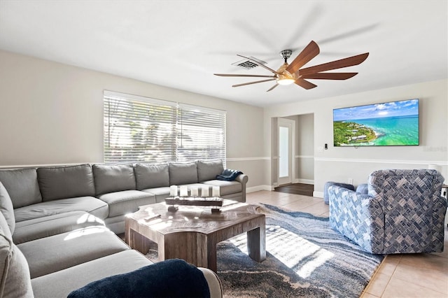 living room featuring ceiling fan and light tile flooring