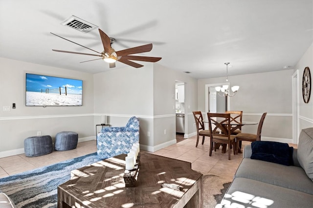 living room with light tile floors and ceiling fan with notable chandelier