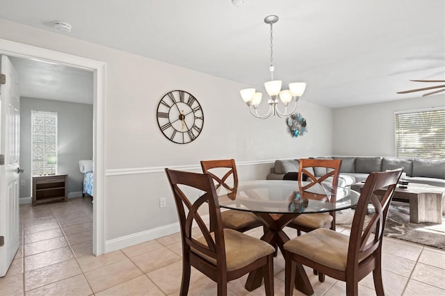 dining area featuring an inviting chandelier and light tile flooring