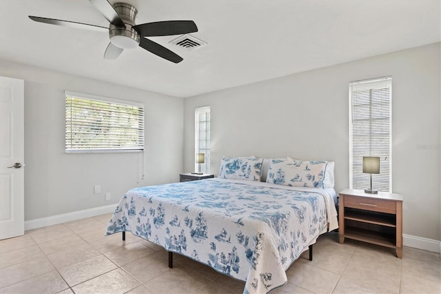 tiled bedroom featuring ceiling fan