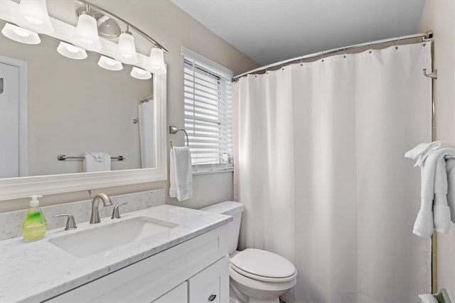 bathroom featuring toilet and large vanity