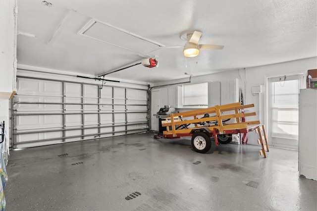 garage featuring ceiling fan and a garage door opener