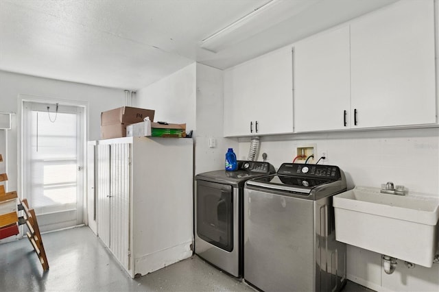 clothes washing area with hookup for a washing machine, washer and dryer, hookup for an electric dryer, sink, and cabinets