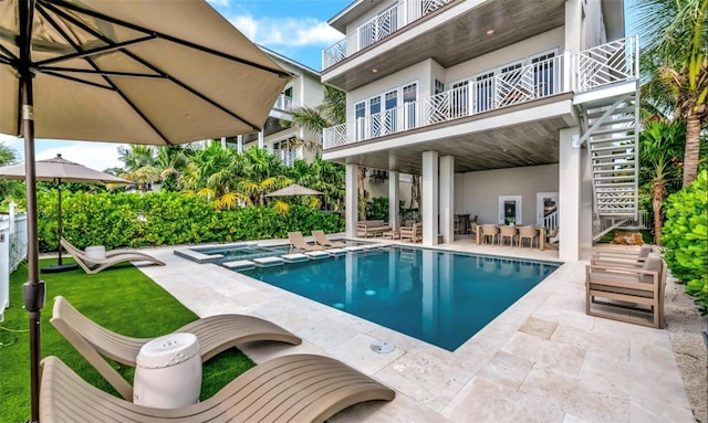 view of pool featuring an in ground hot tub and a patio