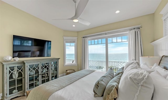 bedroom with access to outside, a water view, and ceiling fan