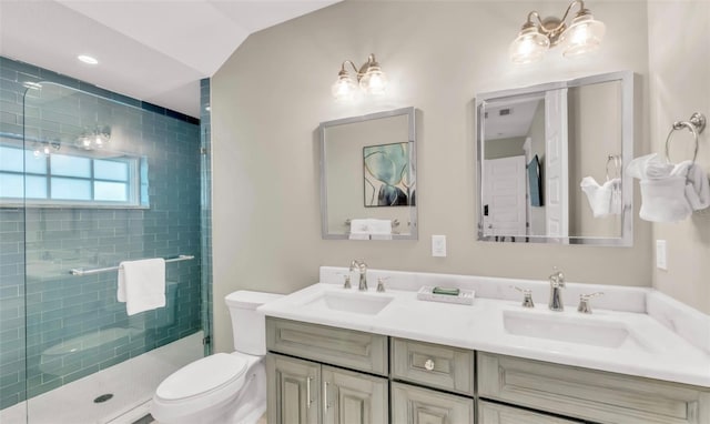 bathroom with walk in shower, vanity, vaulted ceiling, and toilet