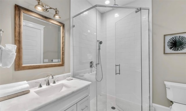 bathroom featuring vanity, toilet, and walk in shower