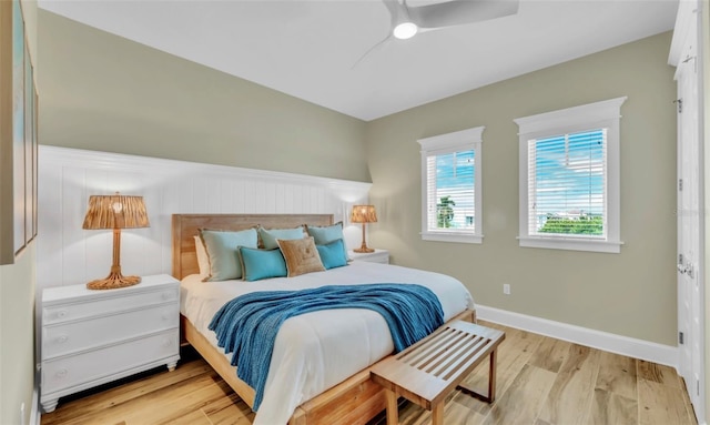 bedroom with ceiling fan and light hardwood / wood-style floors