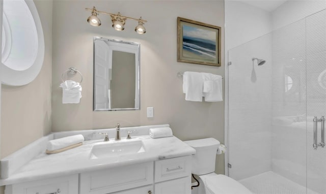 bathroom with vanity, toilet, and an enclosed shower