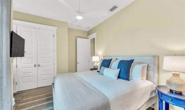 bedroom with hardwood / wood-style floors and a closet