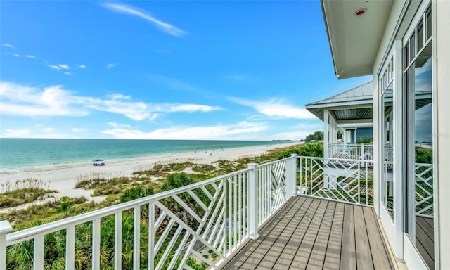 balcony featuring a water view and a view of the beach