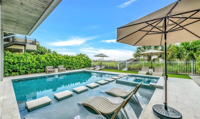 view of pool with a patio area and an in ground hot tub