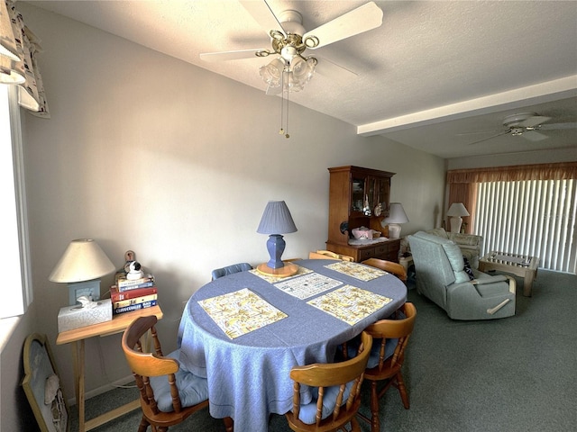 dining room featuring a textured ceiling, carpet floors, and ceiling fan