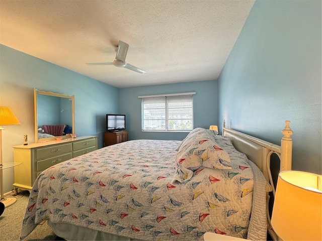 bedroom featuring ceiling fan, carpet, and a textured ceiling