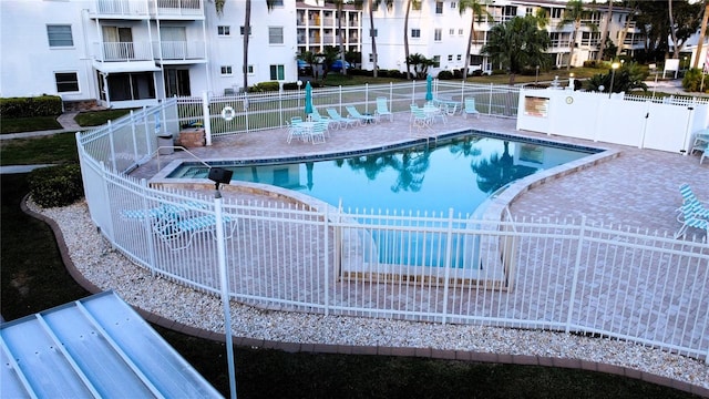 view of pool with a patio and a hot tub