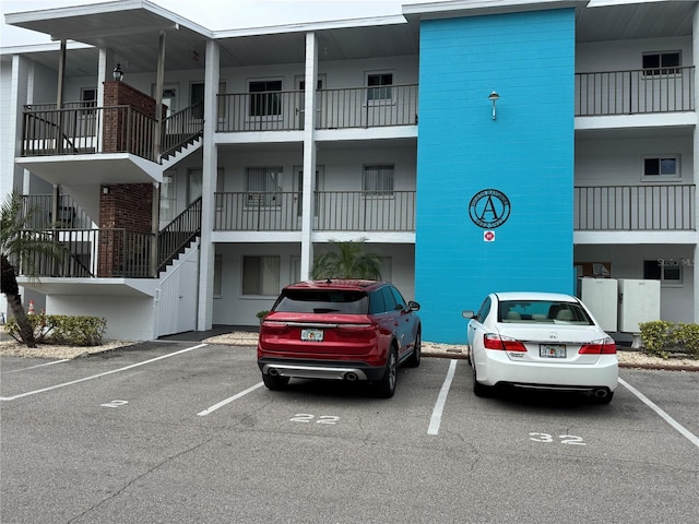 view of building exterior featuring uncovered parking