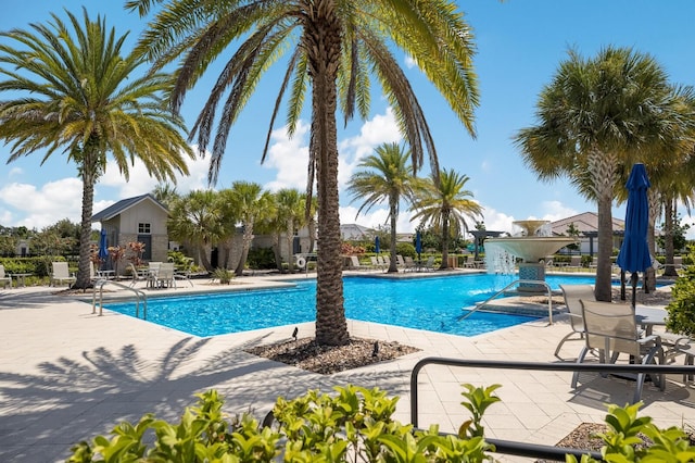 view of swimming pool featuring pool water feature and a patio area