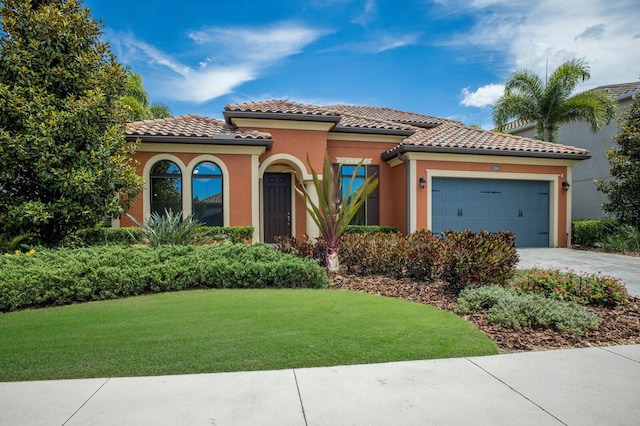 mediterranean / spanish-style house featuring a front yard and a garage