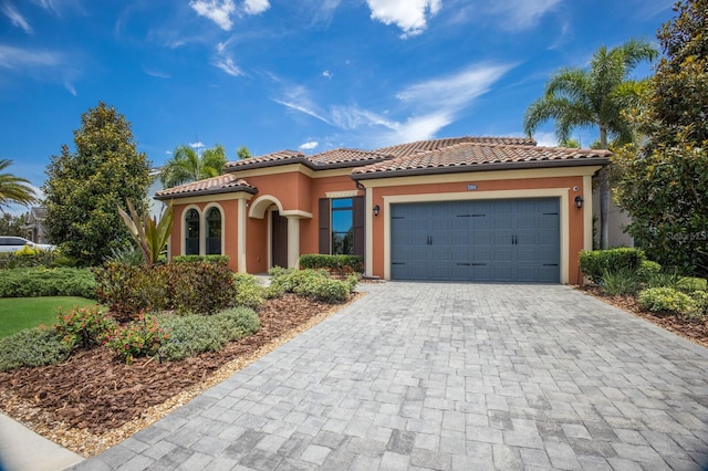 mediterranean / spanish-style home with a garage