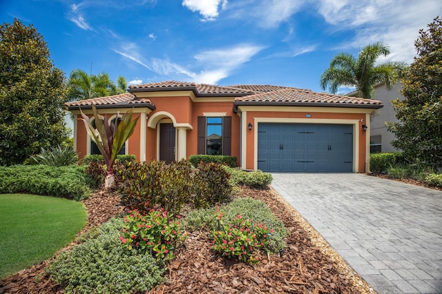 mediterranean / spanish-style home with a garage