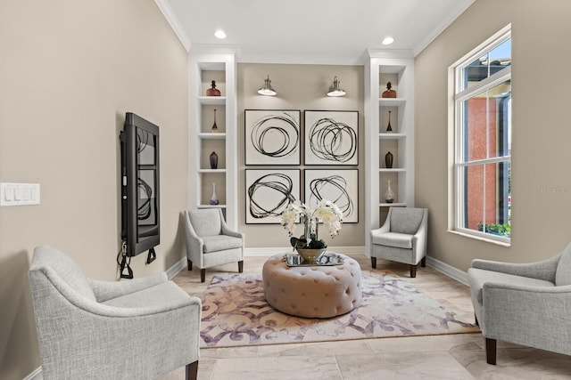 living area with built in shelves, a healthy amount of sunlight, and ornamental molding