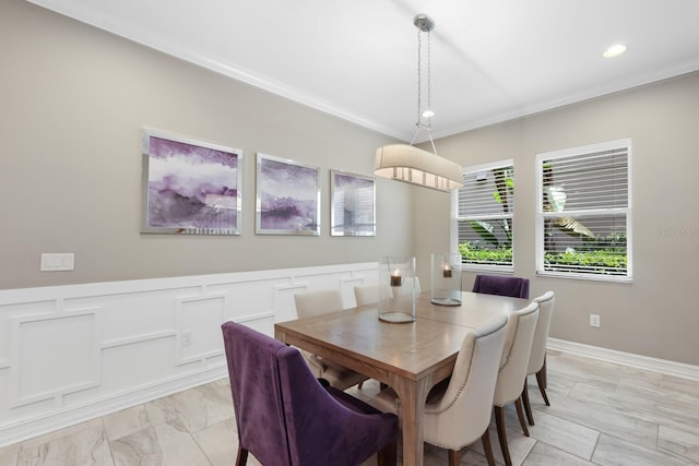 dining space with ornamental molding